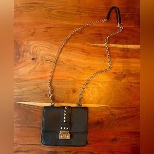 Black studded BCBG crossbody bag with gold chain strap